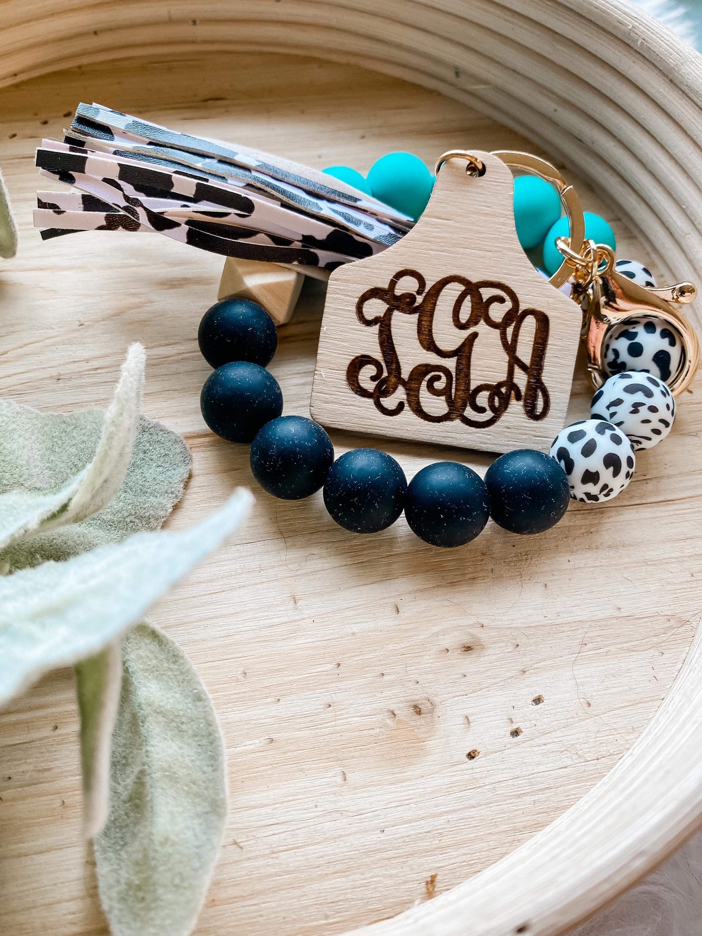 Monogram cow tag wristlet